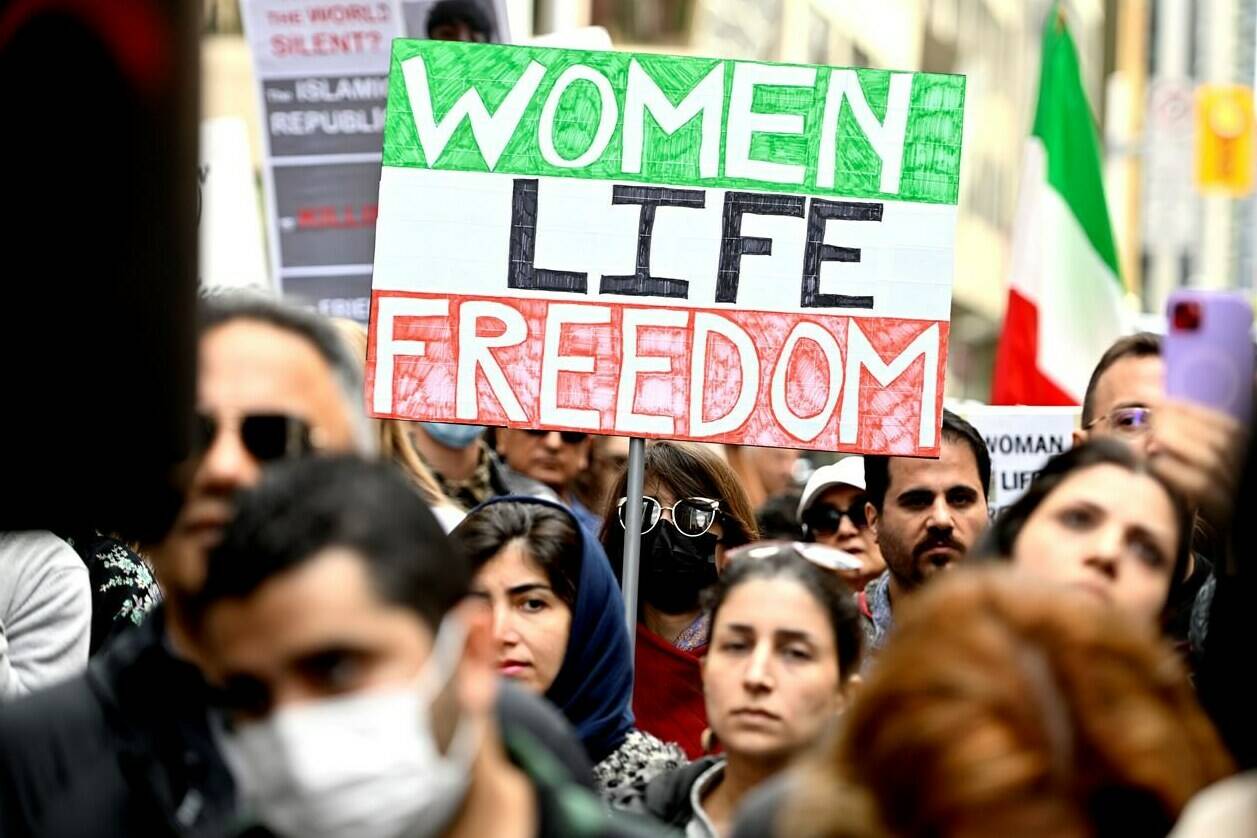 Women Life Free Poster A activist holding in The Mahsa Amini Protest