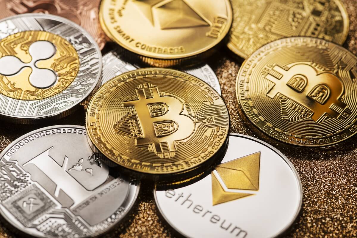 Bitcoin, Litecoin, XRP, Ethereum coins lying around